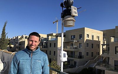 Boaz Nehemia of Yerushamayim, Jerusalem's local weather forecaster, who forecasts the weather with his home weather station on the roof of his building (Jessica Steinberg/Times of Israel)