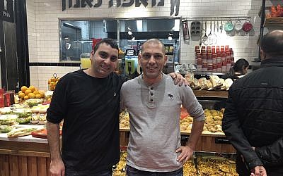 Yaniv Neeman (left) and his latest franchisee, Amjad Awadalla, at the 56th Cafe Neeman, just opened in the new Atarot Mall (Jessica Steinberg/Times of Israel)