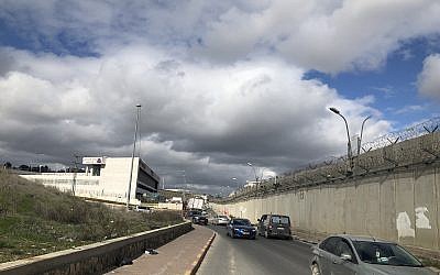 The new mall is across the road from the separation barrier, which splits the Palestinian neighborhood of Beit Hanina (Jessica Steinberg/Times of Israel)