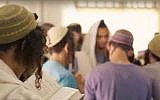 Illustrative: Students pray at the Pri Haaretz yeshiva in the northern West Bank settlement of Rehelim. (Screen capture/YouTube)