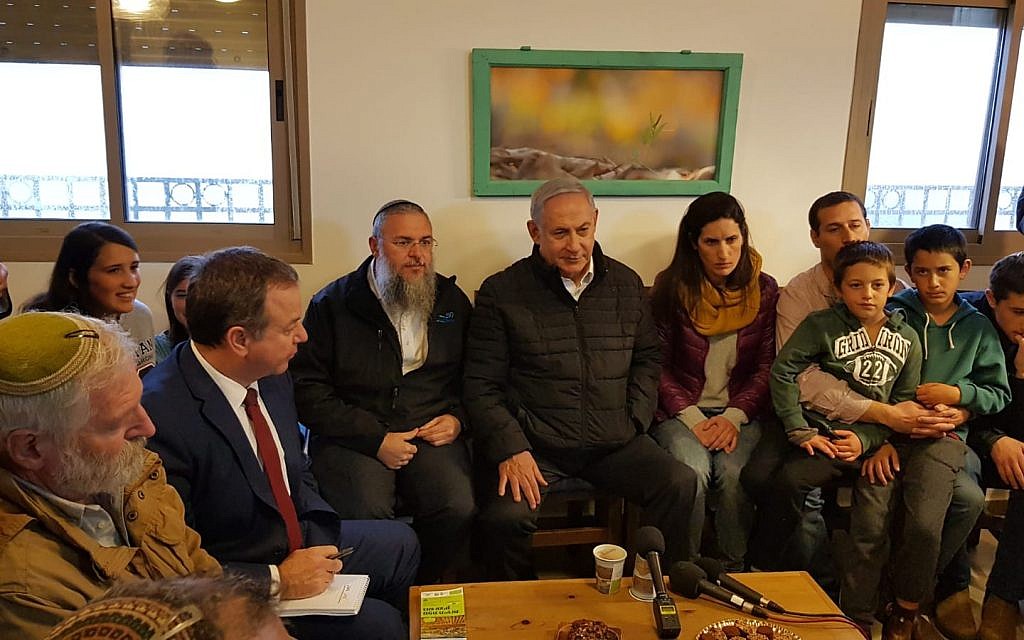 Prime Minister Benjamin Netanyahu (C) meeting families whose homes in the Netiv Ha'avot outpost were demolished last year, at the Elazar West Bank settlement, January 28, 2019. (Gush Etzion Regional Council)