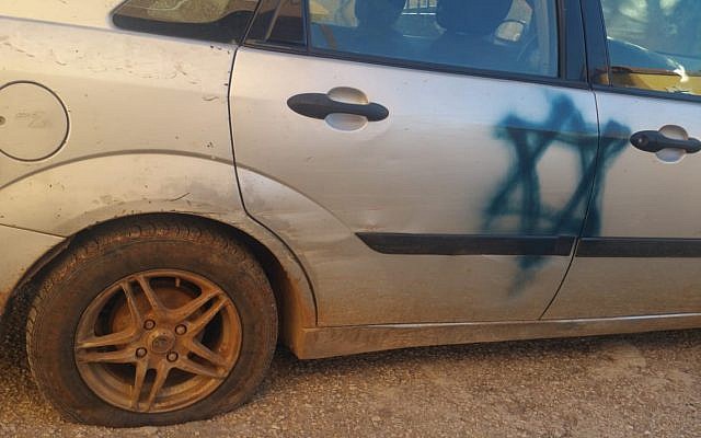 A car spray-painted with a Star of David and whose tires were slashed in an apparent hate crime in the northern West bank village of Luban a-Sharqiya on January 30, 2019. (Courtesy) A car spray-painted with a Star of David and whose tires were slashed in an apparent hate crime in the northern West bank village of Luban a-Sharqiya on January 30, 2019. (Courtesy)