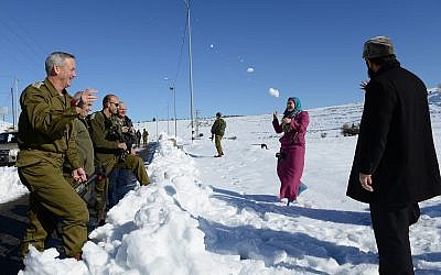Then-IDF chief of staff Benny Gantz has a snowball fight with a family of Palestinians along the West Bank's Route 60 on December 15, 2013. (Judah Ari Gross/Israel Defense Forces)