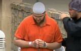 Damon Joseph, center, accompanied by a federal agent, right, during his arrest on December 10, 2018, for plotting to carry out a mass shooting attack at an Ohio synagogue. (Screen capture WTAE-TV)