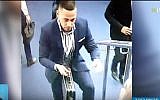 A man carries a briefcase believed to contain hundreds of thousands of shekels in diamonds stolen from the Ramat Gan Diamond Exchange on January 28, 2019. (screen capture: Kan broadcaster)