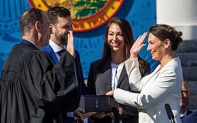 Nikki Fried, right, is sworn in as Florida's commissioner of agriculture on January 8, 2019. Fried's left hand is placed on the first Hebrew Bible published in America. (Photo by Colin Hackley/via RNS)