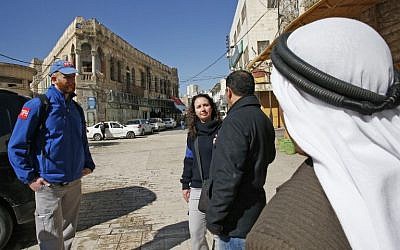 Members of the Temporary International Presence in Hebron (TIPH) talk to local Palestinians as they walk in the West Bank city on January 29, 2019. (Hazem Bader/AFP)