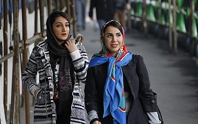In this file photo taken on February 7, 2018, Iranian women wearing hijab walk down a street in the capital Tehran. (Atta Kenare/AFP)