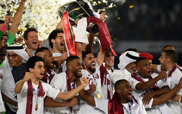 Qatar's players celebrate with the trophy after winning the 2019 AFC Asian Cup final soccer match between Japan and Qatar at the Zayed Sports City Stadium in Abu Dhabi, on February 1, 2019. (Roslan RAHMAN/AFP) Qatar's players celebrate with the trophy after winning the 2019 AFC Asian Cup final soccer match between Japan and Qatar at the Zayed Sports City Stadium in Abu Dhabi, on February 1, 2019. (Roslan RAHMAN/AFP)