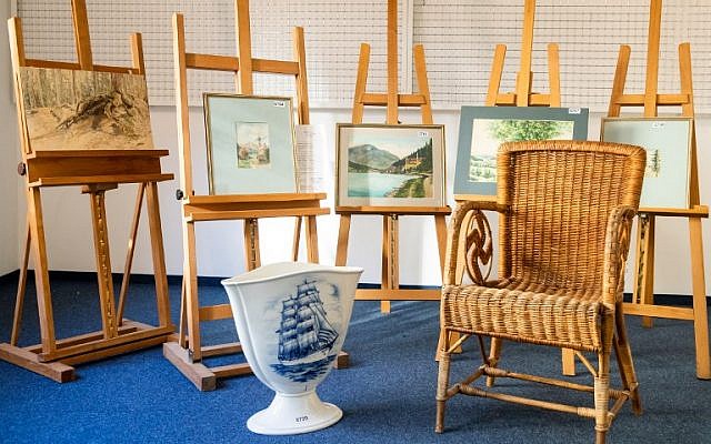 A picture taken on February 8, 2019, at the Weidler auction house in the southern German city of Nuremberg shows a wicker armchair, bearing a swastika, a vase and watercolors which are presumed to have belonged to late Nazi dictator Adolf Hitler. (Daniel Karmann/AFP) A picture taken on February 8, 2019, at the Weidler auction house in the southern German city of Nuremberg shows a wicker armchair, bearing a swastika, a vase and watercolors which are presumed to have belonged to late Nazi dictator Adolf Hitler. (Daniel Karmann/AFP)