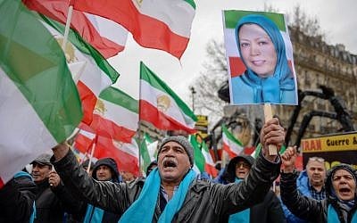People wave former Iranian flags and a picture of Maryam Rajavi, leader of the People's Mujahedin of Iran, during a demonstration of the exiled Iranian opposition to protest against the Iranian government on February 8, 2019 in Paris. (AFP)