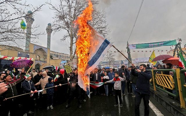 Iranians burn Israeli flags during commemorations in the capital Tehran of the 40th anniversary of the Islamic on February 11, 2019. (Atta Kenare/AFP) Iranians burn Israeli flags during commemorations in the capital Tehran of the 40th anniversary of the Islamic on February 11, 2019. (Atta Kenare/AFP)