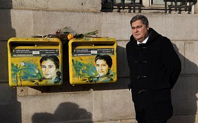 French lawyer Pierre-Francois Veil poses next to recently vandalized letter boxes displaying a portrait of his mother, late French politician and Holocaust survivor Simone Veil, on February 11, 2019 in the 13th arrondissement of Paris. (Christophe Archambault/AFP)