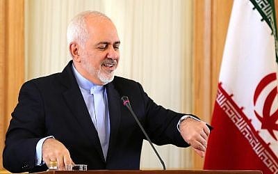 Iran's Foreign Minister Mohammad Javad Zarif checks his watch during a press conference in Tehran, February 13, 2019. (ATTA KENARE/AFP)