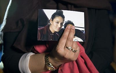 In this file photo taken on February 22, 2015, Renu Begum, eldest sister of British Islamic State member Shamima Begum, holds a picture of her sister while being interviewed by the media in central London. (Laura Lean/Pool/AFP)