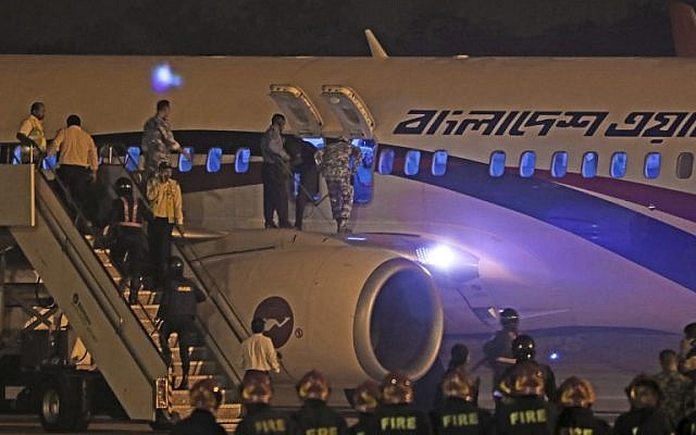 Bangladeshi security personnel stand guard near a Dubai-bound Bangladesh Biman plane on the tarmac of the Shah Amanat International Airport in Chittagong on February 24, 2019, following an emergency landing after a man apparently attempted to hijack the aircraft. (Photo by STR / AFP) Bangladeshi security personnel stand guard near a Dubai-bound Bangladesh Biman plane on the tarmac of the Shah Amanat International Airport in Chittagong on February 24, 2019, following an emergency landing after a man apparently attempted to hijack the aircraft. (Photo by STR / AFP)