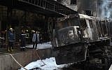 Fire fighters and onlookers gather at the scene of a fiery train crash at the Egyptian capital Cairo's main railway station on February 27, 2019 (Hussein Talal / AFP)