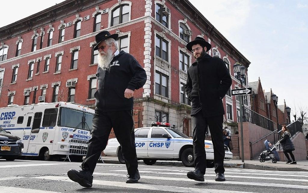 Jewish men walk past a 'Crown Heights Shmira Patrol' security vehicles in the Brooklyn neighborhood of Crown Heights on February 27, 2019 in New York. (Angela Weiss/AFP) Jewish men walk past a 'Crown Heights Shmira Patrol' security vehicles in the Brooklyn neighborhood of Crown Heights on February 27, 2019 in New York. (Angela Weiss/AFP)