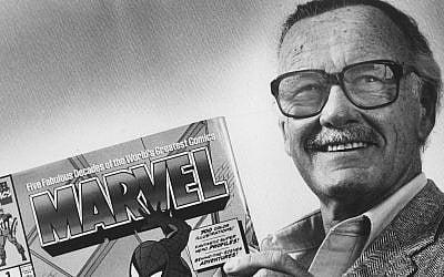 Stan Lee poses with a book of 'Spider Man' comics in 1991. Along with Spider Man, Lee created characters such as Iron Man, Thor and The Incredible Hulk. (Gerald Martineau/The Washington Post via Getty Images)