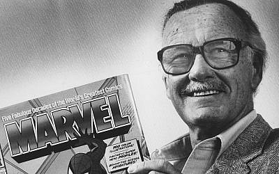Stan Lee poses with a book of 'Spider Man' comics in 1991. Along with Spider Man, Lee created characters such as Iron Man, Thor and The Incredible Hulk. (Gerald Martineau/The Washington Post via Getty Images via JTA)