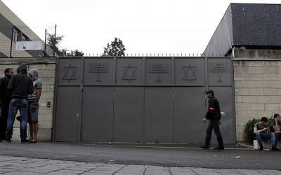 People stand in front of a synagogue with its doors closed in Sarcelles, a suburb north of Paris, on July 20, 2014. (KENZO TRIBOUILLARD/AFP/Getty Images)