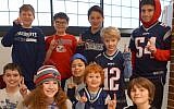 Students at the MetroWest Jewish Day School in Framingham, Mass., show off gear for their favorite team on Patriots Ruach (Spirit) Day, Feb. 1, 2019. (Courtesy of MetroWest Jewish Day School)