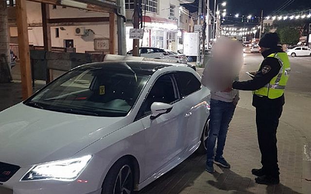 Police question a 15-year-old boy who helped his brother, 5, drive their parents' car. (Israel Police)