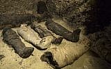 Mummies lie in a recently discovered burial chamber in the desert province of Minya, south of Cairo, Egypt on February 2, 2019. (AP Photo/Roger Anis)