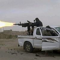 This frame grab from video posted online January 18, 2019, by supporters of the Islamic State group, purports to show a gun-mounted Islamic State group vehicle firing at members of the US-backed Syrian Democratic Forces, in the eastern Syrian province of Deir el-Zour, Syria. (Militant Photo via AP)