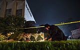 In this October 27, 2018 photo, Rabbi Eli Wilansky lights a candle after a mass shooting at the Tree of Life Synagogue in Pittsburgh's Squirrel Hill neighborhood. (Steph Chamber/ Pittsburgh Post-Gazette via AP, File)