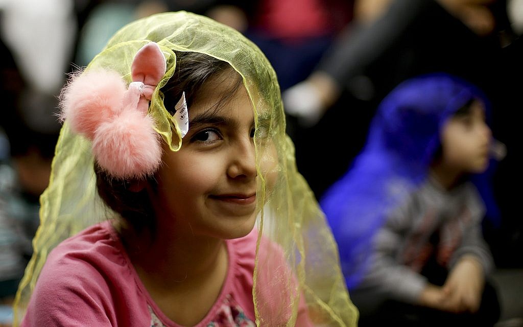 In this Wednesday, January 23, 2019, photo, Melorin Issarezal, 8, plays with a scarf during Persian story time at Irvine public library in Irvine, California. (AP Photo/Chris Carlson) In this Wednesday, January 23, 2019, photo, Melorin Issarezal, 8, plays with a scarf during Persian story time at Irvine public library in Irvine, California. (AP Photo/Chris Carlson)