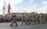 In this August 15, 2018, photo, a group of US Army soldiers take part in an annual military parade celebrating Polish Army Day in Warsaw, Poland. (AP Photo/Alik Keplicz, File)