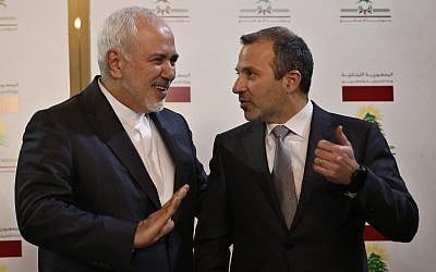 Lebanese Foreign Minister Gebran Bassil, right, speaks with his Iranian counterpart Mohammad Javad Zarif, in Beirut, Lebanon, on February 11, 2019. (AP Photo/Hussein Malla)