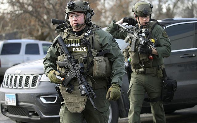 Police officers armed with rifles gather at the scene where an active shooter was reported in Aurora, Illinois on Friday, Feb. 15, 2019. (Antonio Perez/Chicago Tribune via AP) Police officers armed with rifles gather at the scene where an active shooter was reported in Aurora, Illinois on Friday, Feb. 15, 2019. (Antonio Perez/Chicago Tribune via AP)