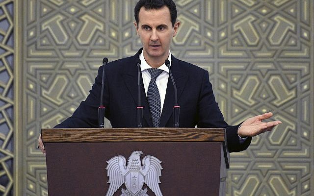In this photo released by the Syrian official news agency SANA, Syrian President Bashar Assad speak during meeting with heads of local councils from all Syrian provinces, in Damascus, Syria, Sunday, Feb. 17, 2018. (SANA via AP) In this photo released by the Syrian official news agency SANA, Syrian President Bashar Assad speak during meeting with heads of local councils from all Syrian provinces, in Damascus, Syria, Sunday, Feb. 17, 2018. (SANA via AP)