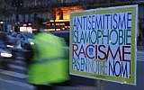 A poster reading 'Anti-Semitism, Islamophobia, Racism, Not in Our Name" during a gathering decrying anti-Semitism at Place de la Republique in Paris, February 18, 2019 amid an upsurge in anti-Semitism in France. (AP/Francois Mori)