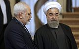 Iranian President Hassan Rouhani, right, listens to his Foreign Minister Mohammad Javad Zarif prior to a meeting in Tehran, Iran, November 24, 2015. (Vahid Salemi/AP)