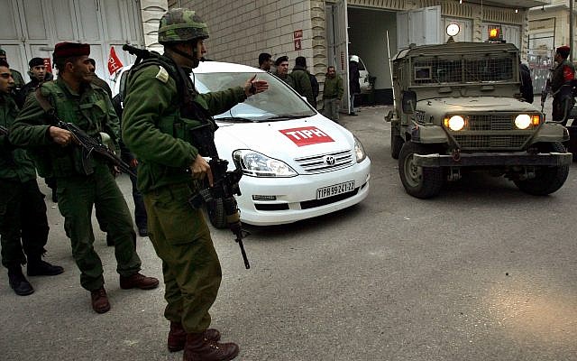 Soldiers stand near a car used by members of the TIPH, Temporary International Presence in Hebron on Wednesday, Feb. 8, 2006. (AP Photo/Emilio Morenatti) Soldiers stand near a car used by members of the TIPH, Temporary International Presence in Hebron on Wednesday, Feb. 8, 2006. (AP Photo/Emilio Morenatti)