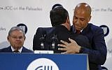 Then New Jersey Gov. Chris Christie, center, is hugged by US Sen. Cory Booker, right, after speaking to a crowd at the Kaplen Jewish Community Center on the Palisades during a rally against bomb threats made to Jewish centers, Friday, March 3, 2017, in Tenafly, New Jersey. (AP Photo/Julio Cortez)
