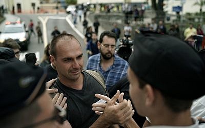 Eduardo Bolsonaro greets students as he leaves the Santa Casa hospital where his father was hospitalized in Juiz de Fora, Brazil, Sept. 6, 2018 (AP Photo/Leo Correa)