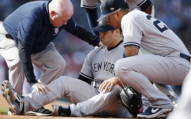 A trainer attends to New York Yankees' Luis Cessa, center, after he was injured on a play at first base during the first inning of a baseball game against the Boston Red Sox in Boston, Sunday, Sept. 30, 2018. (AP Photo/Michael Dwyer) A trainer attends to New York Yankees' Luis Cessa, center, after he was injured on a play at first base during the first inning of a baseball game against the Boston Red Sox in Boston, Sunday, Sept. 30, 2018. (AP Photo/Michael Dwyer)