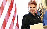In this photo from September 6, 2018, Georgette Mosbacher stands next to an American flag after receiving her credentials as new United States ambassador to Poland in Warsaw. (AP Photo/Czarek Sokolowski, File)