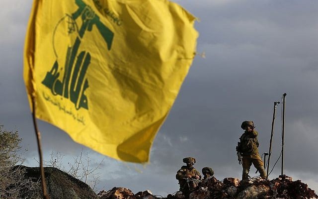 In this photo from December 13, 2018, Israeli soldiers stand guard next to cameras at their new position in front of a Hezbollah flag, near the Lebanese southern border village of Mays al-Jabal, Lebanon. (AP Photo/Hussein Malla) In this photo from December 13, 2018, Israeli soldiers stand guard next to cameras at their new position in front of a Hezbollah flag, near the Lebanese southern border village of Mays al-Jabal, Lebanon. (AP Photo/Hussein Malla)