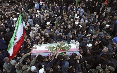 Mourners a carry flag-draped casket during a mass funeral for those killed in a suicide car bombing that targeted members of Iran's Revolutionary Guard in Isfahan, killing at least 27 people. (AP Photo/Ebrahim Noroozi)