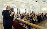 Chief Rabbi of Poland Michael Schudrich, left, who co-wrote the letter of complaint against Israel Katz, seen speaking to visitors in a synagogue in Warsaw in 2015. (AP Photo/Alik Keplicz/File)