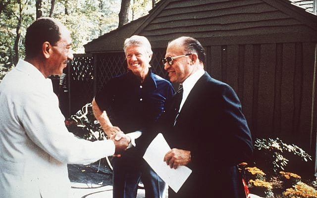 Egypt's president Anwar Sadat, left, shakes hands with Israeli prime minister Menachem Begin, right, as US president Jimmy Carter looks on, in September 1978. (AP) Egypt's president Anwar Sadat, left, shakes hands with Israeli prime minister Menachem Begin, right, as US president Jimmy Carter looks on, in September 1978. (AP)