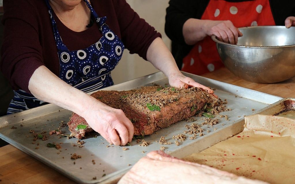 Sheila and Marilynn Brass curing pastrami at Mamaleh's restaurant for their pastrami ramen-noodle kugel. (Courtesy)