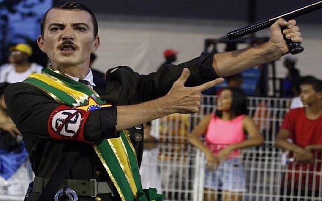 Illustrative: A Brazilian samba school dancer rehearsing for the Carnival parade in a costume criticizing right-wing president Jair Bolsonaro through a mixed depiction of him and Adolf Hitler. (Courtesy/Ismael Toledo via JTA) Illustrative: A Brazilian samba school dancer rehearsing for the Carnival parade in a costume criticizing right-wing president Jair Bolsonaro through a mixed depiction of him and Adolf Hitler. (Courtesy/Ismael Toledo via JTA)