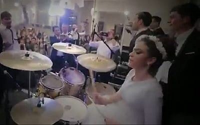 Screen capture from video of bride Shira Hirschkovitz drumming at her own wedding. (YouTube)