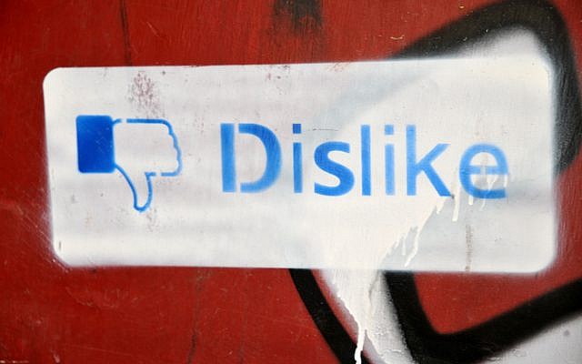 Graffiti on a wall in Jerusalem of a 'dislike' thurmbs-down sign, based on Facebook's thumbs-up 'like' sign. May 26,2011. (Sophie Gordon / Flash 90) Graffiti on a wall in Jerusalem of a 'dislike' thurmbs-down sign, based on Facebook's thumbs-up 'like' sign. May 26,2011. (Sophie Gordon / Flash 90)